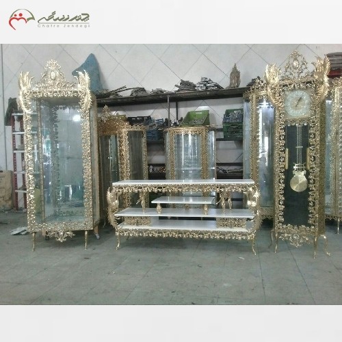 خرید آنلاین، سرویس کامل عروس شامل آینه کنسول، ویترین، ساعت و میز تلویزیون از جنس برنز در رنگ طلایی، زیر قیمت بازار | هنرظریف