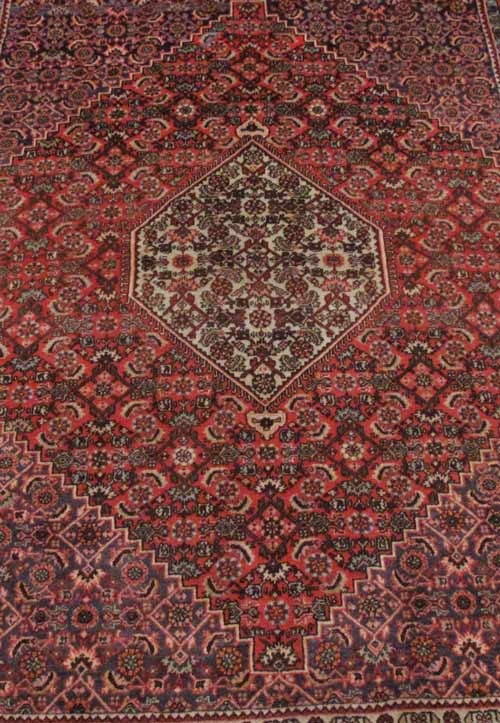 فرش دستباف بيجار طرح لچک و ترنج سایز ذرع و نيم رنگ زمینه نارنجي رنگ حاشیه نارنجي کد ۳۸۸۹۹